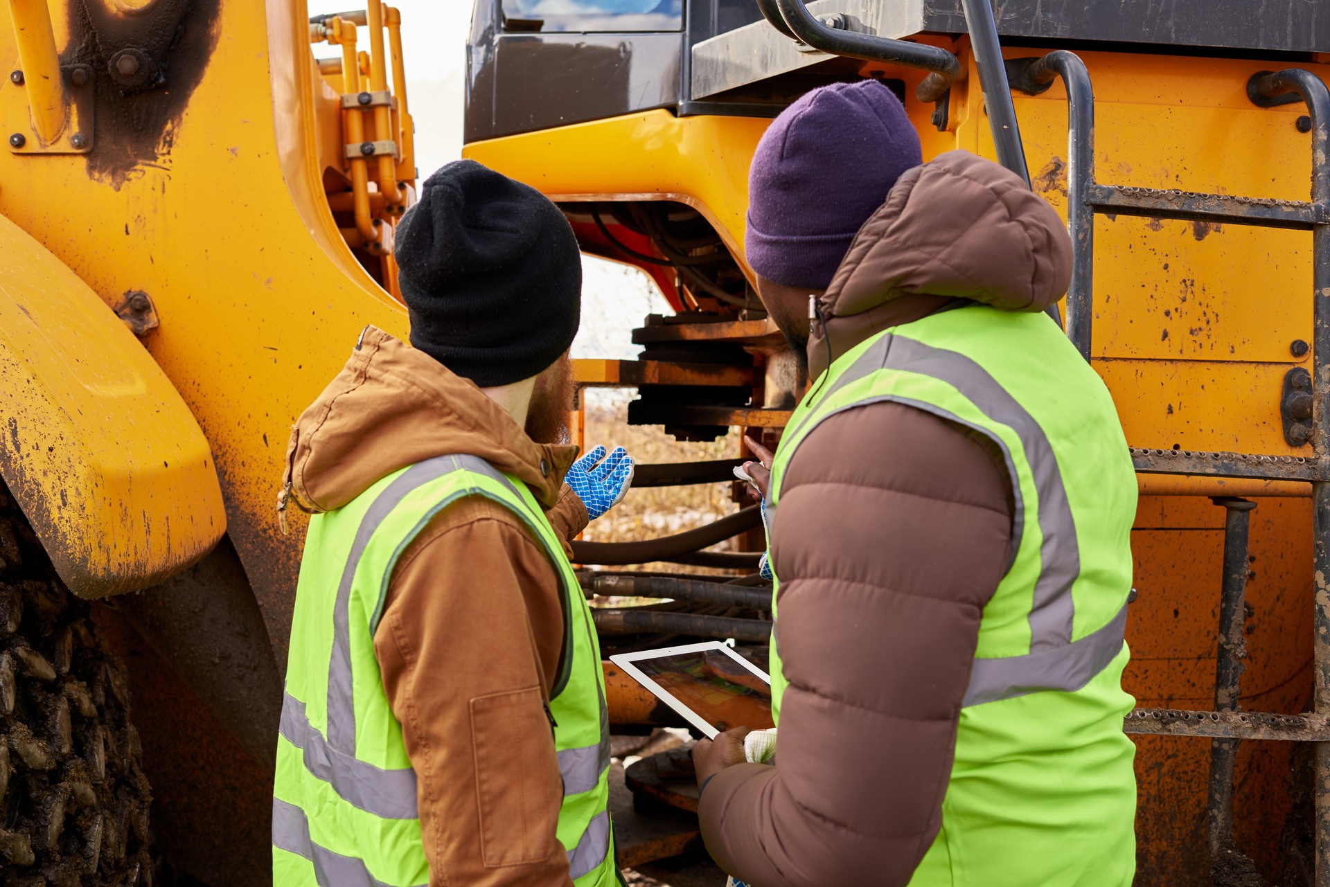 Mechanics Inspecting Truck Outdoors